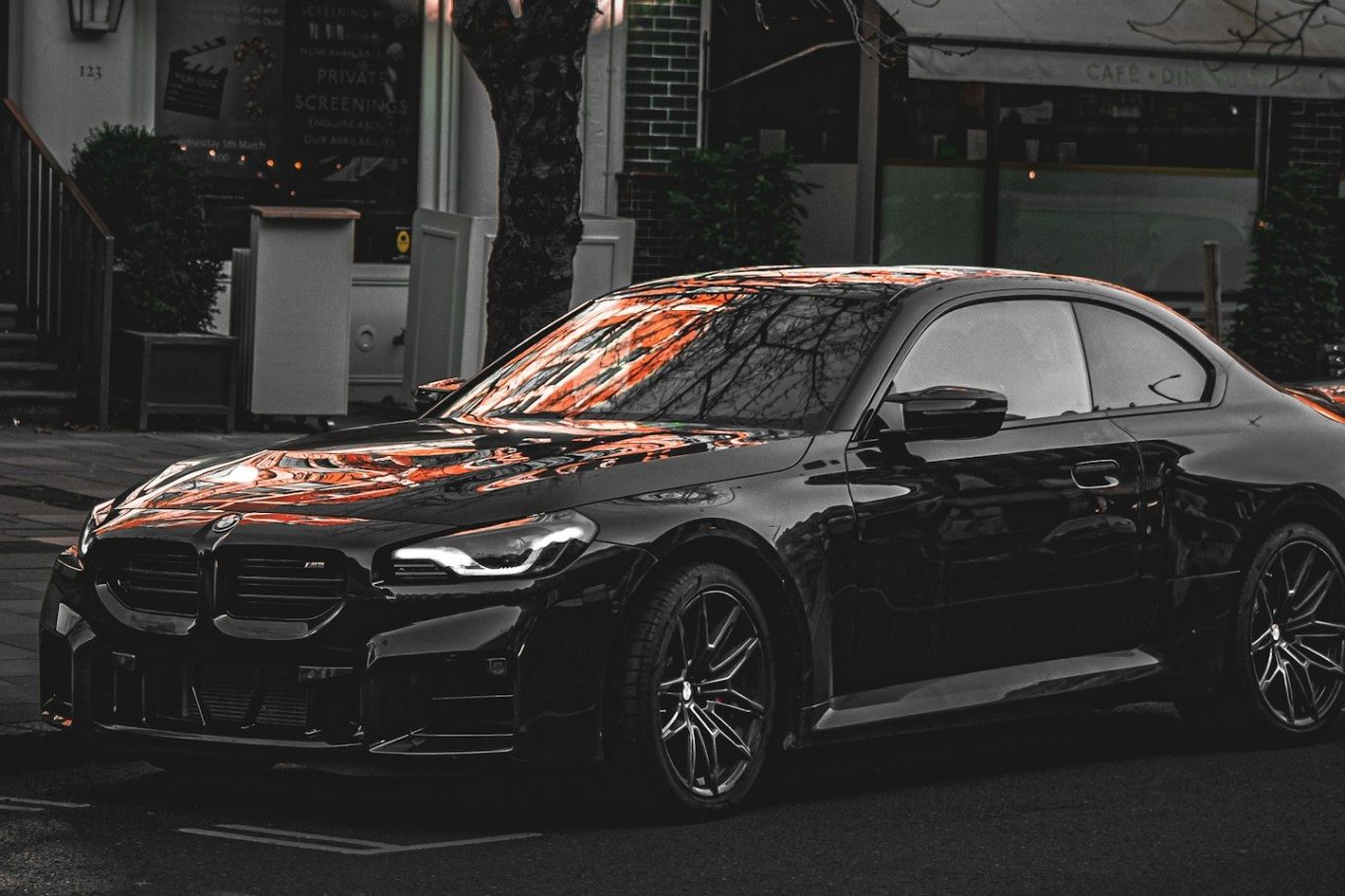Two luxury Mercedes-Benz cars parked next to each other in a garage.